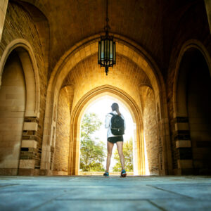 Image of student walking under Myron Taylor arches.